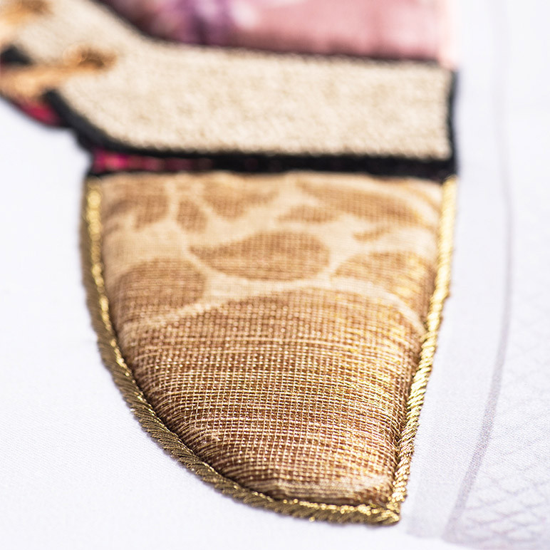 closeup fabric and embroidery detail of the front of a shoe