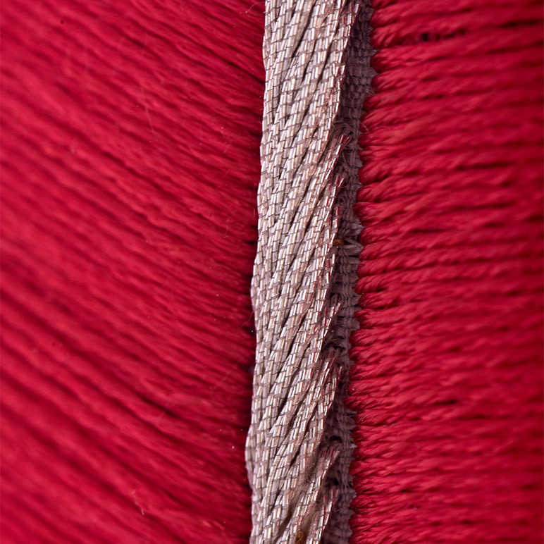 closeup embroidery detail of a deep pink textile art