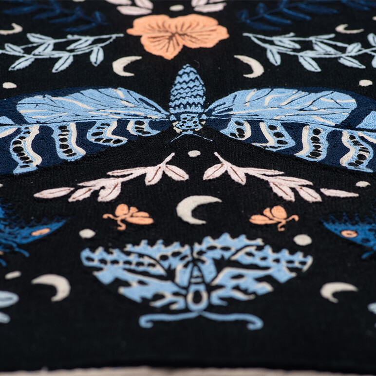 close-up view showing the embroidery detail on a chainstitched tapestry with a large blue butterfly
