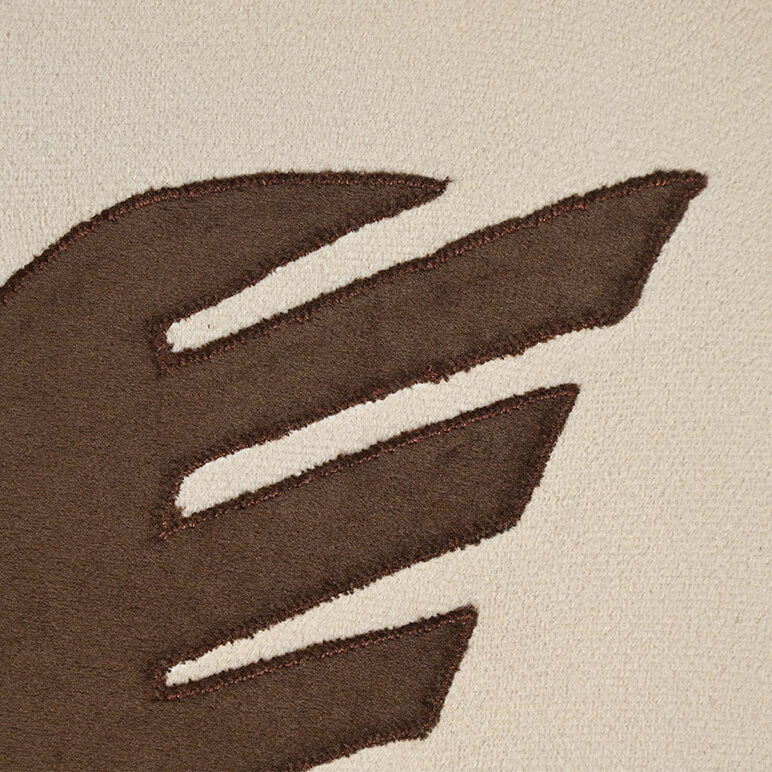 Close up detail showing the patchwork in earthy color tone over a beige background
