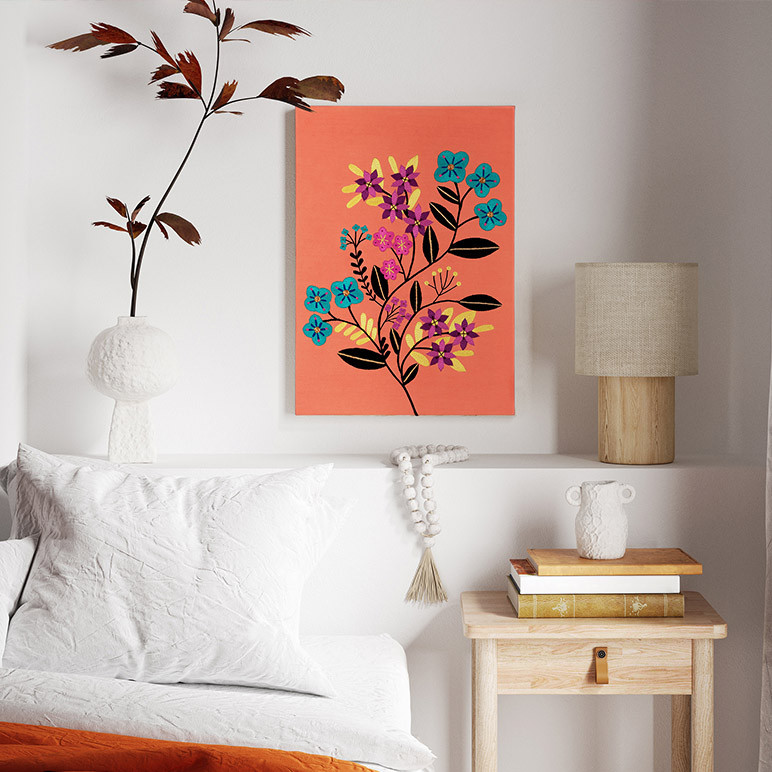 an orange canvas framed wall art displayed in a bohemian bedroom