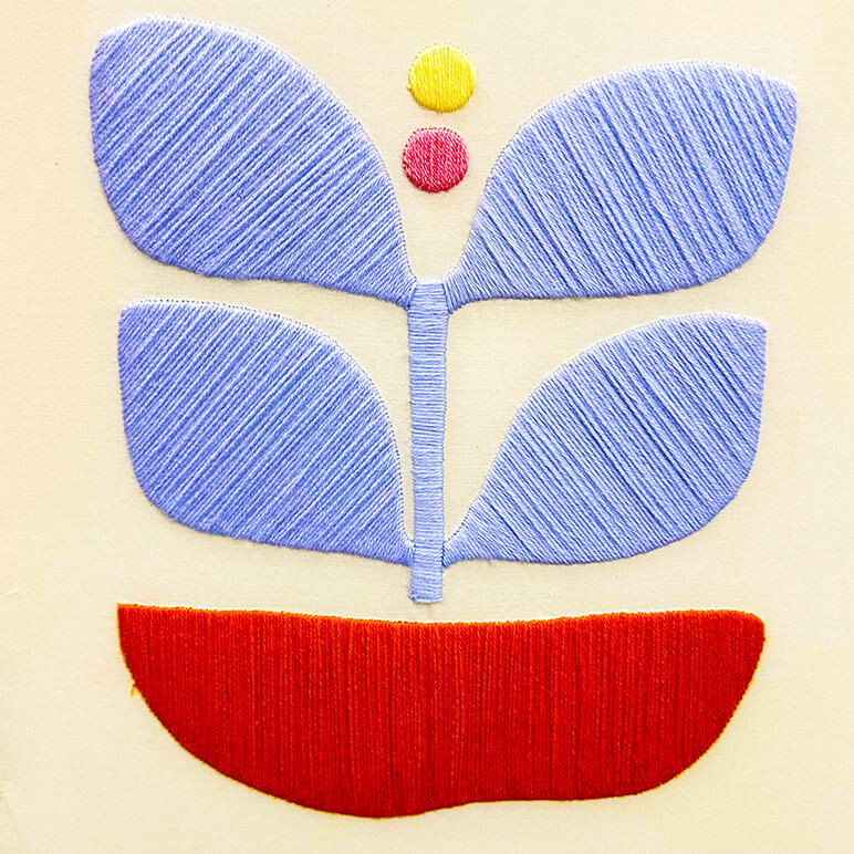 Embroidery details of a blue abstract wall art, done in wool