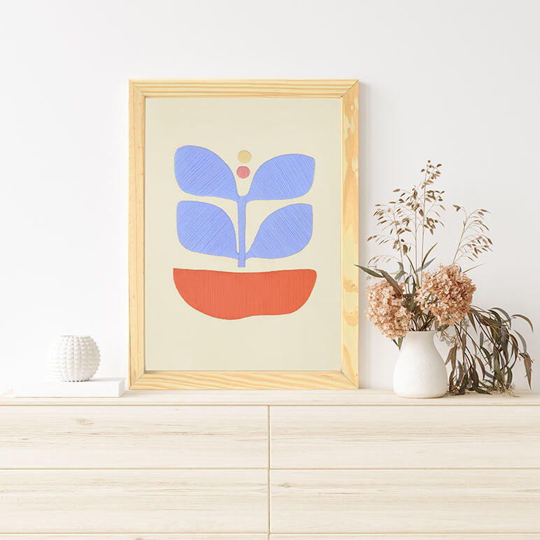 Blue abstract wall art in pastel blue and pops of orange, seen displayed over a wooden console table