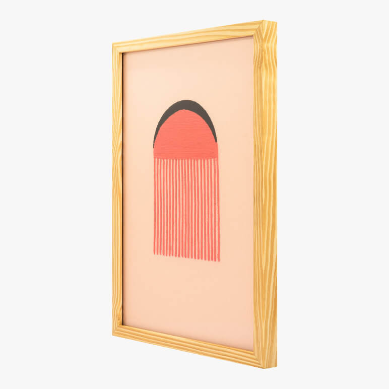 side angle view of a framed pink textile wall artwork displayed in a wooden frame