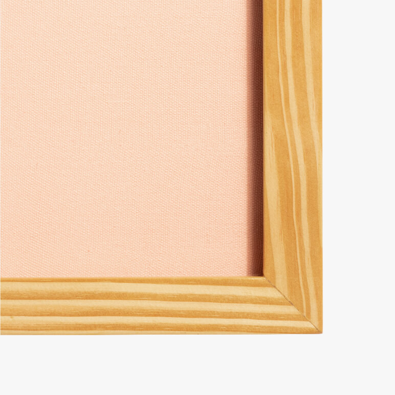 corner view of a pink wall art showing a wooden frame