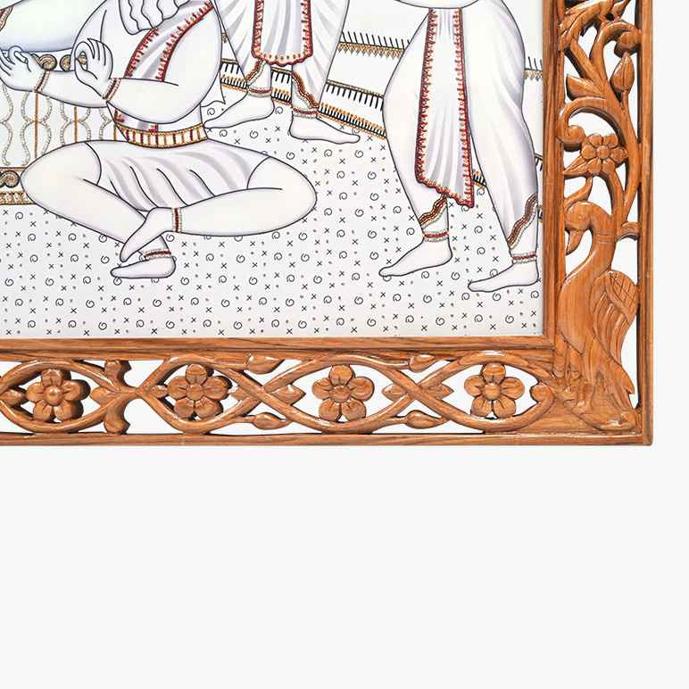 Corner view of the hand-carved wooden frame ensconcing Ram Darbar artwork
