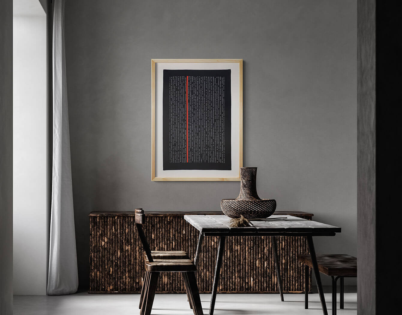 A chic industrial grey dining room exudes contemporary charm, enhanced by the presence of the framed textile artwork 'Meet you after midnight.' The captivating blend of kantha embroidery and abstract design adds an artistic touch.