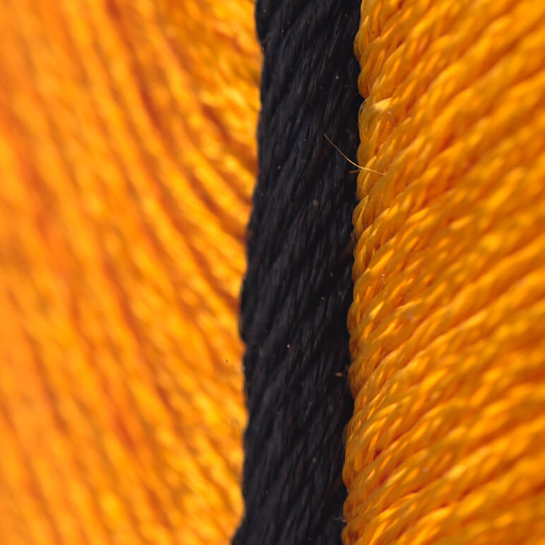 close-up view of yellow and black silk embroidery