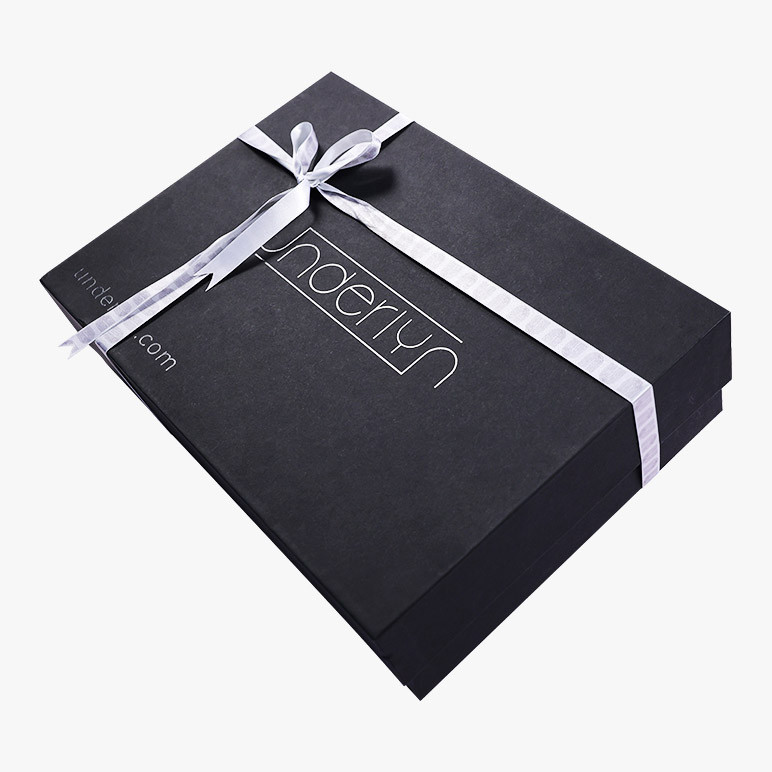 branded black gift box with a tied silver ribbon and underlyn insignia on it