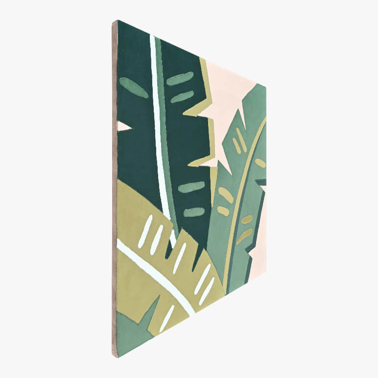 Left angle view of a tropical wall art, canvas framed and showcasing banana leaves in green color tones