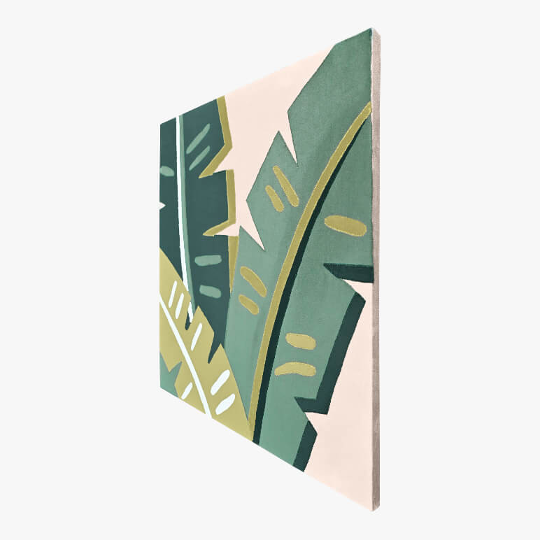 Right angle view of a tropical wall art, canvas framed and showcasing banana leaves in green color tones