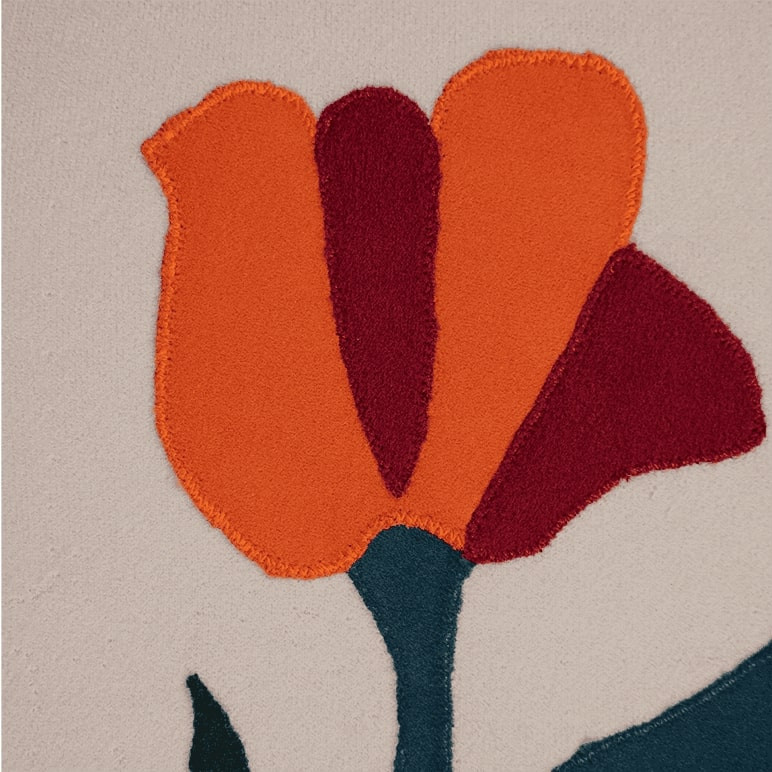 Close up view of the embroidery details in patchwork on a tulip wall art