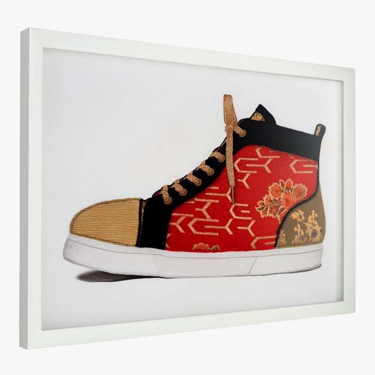 side view of framed red sneaker fabric artwork