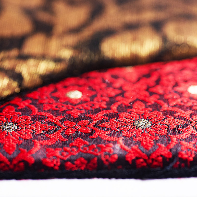 fabric art in red, black and gold colors