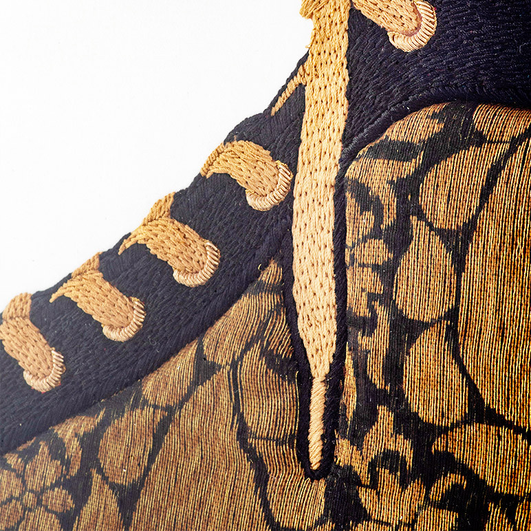 closeup embroidery detail of black sneaker art