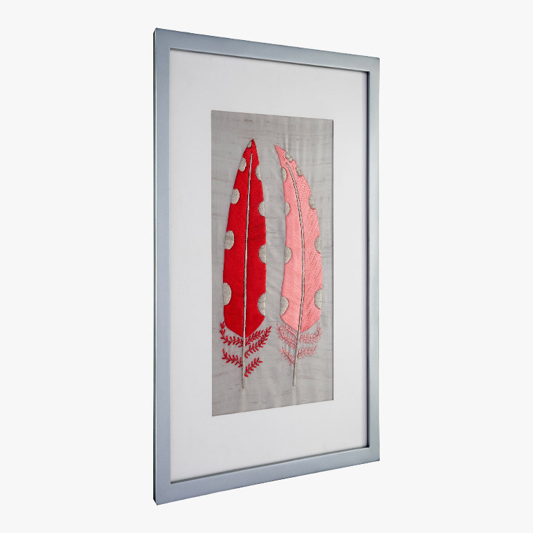 side angle view of a silver frame holding a pink feather modern farmhouse wall art
