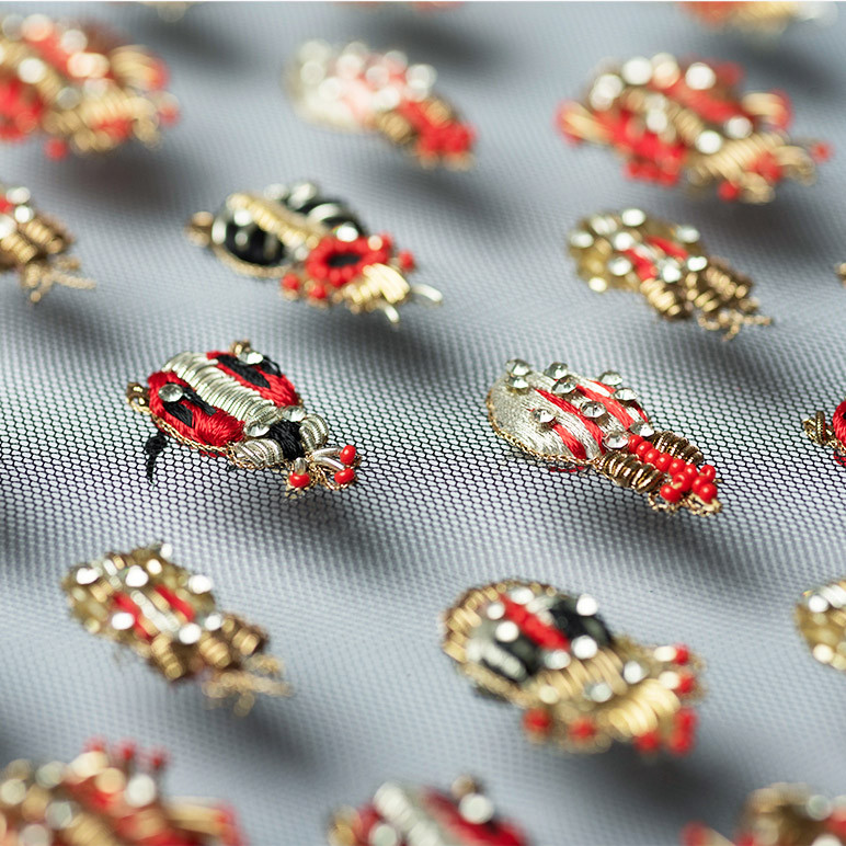 closeup of embroidered beetles in unique wall art