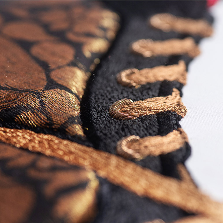 gold lace detail of a black artwork