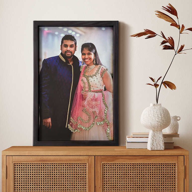staged view of a couple's portrait seen displayed on a wooden table