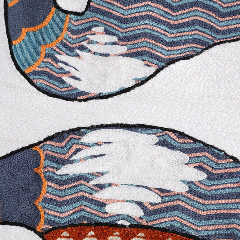 woolen embroidery in white and blue colors showing the chest and neck of a pair of Sandhill cranes on a white wall hanging