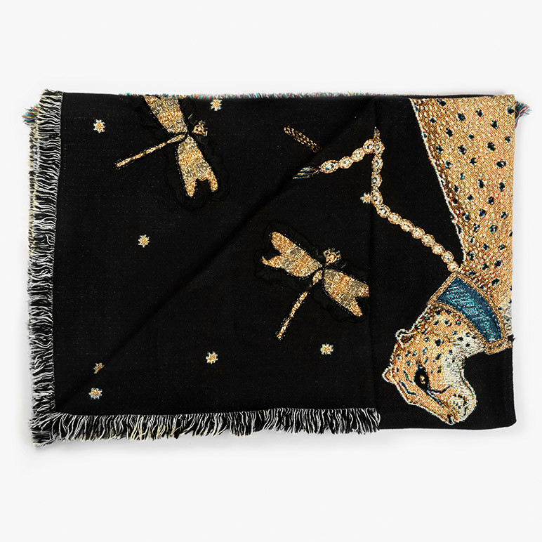 view of a folded woven throw blanket in deep black color with a yellow cheetah and golden dragonflies on it