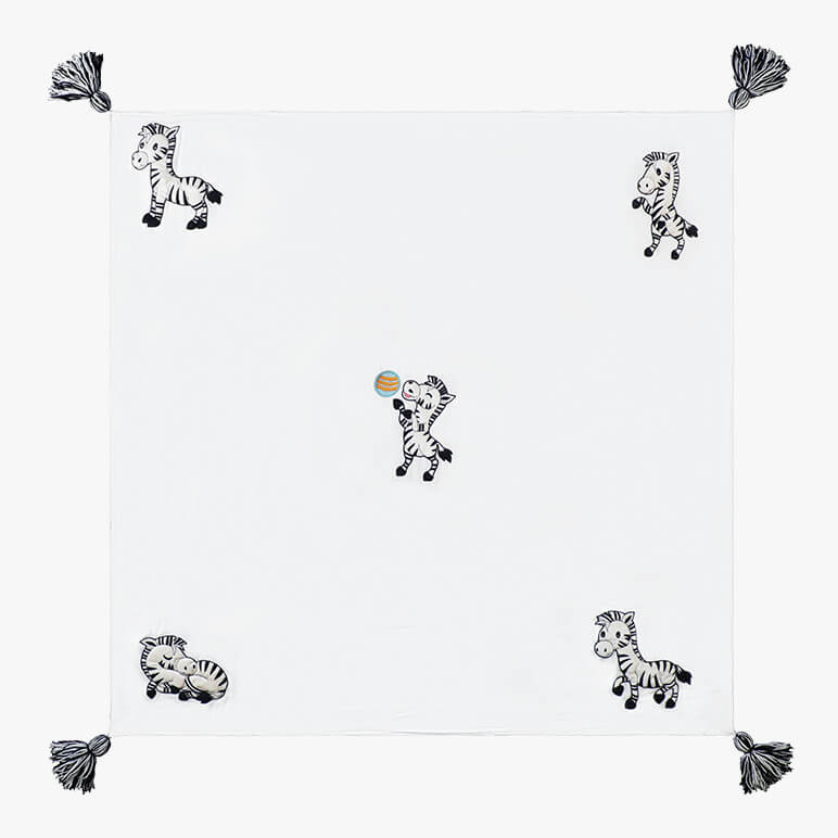cute zebra throw blanket for kids with five zebras in different poses and four wool tassels in black and white