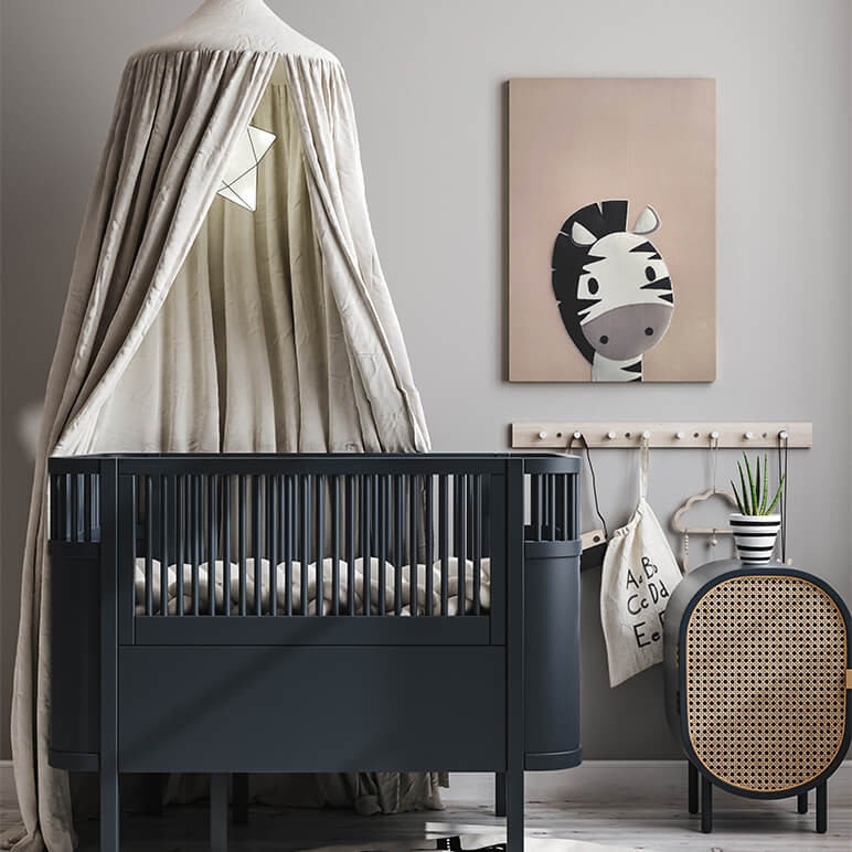 staged view of a grey nursery seen displayed with a cute zebra wall artwork