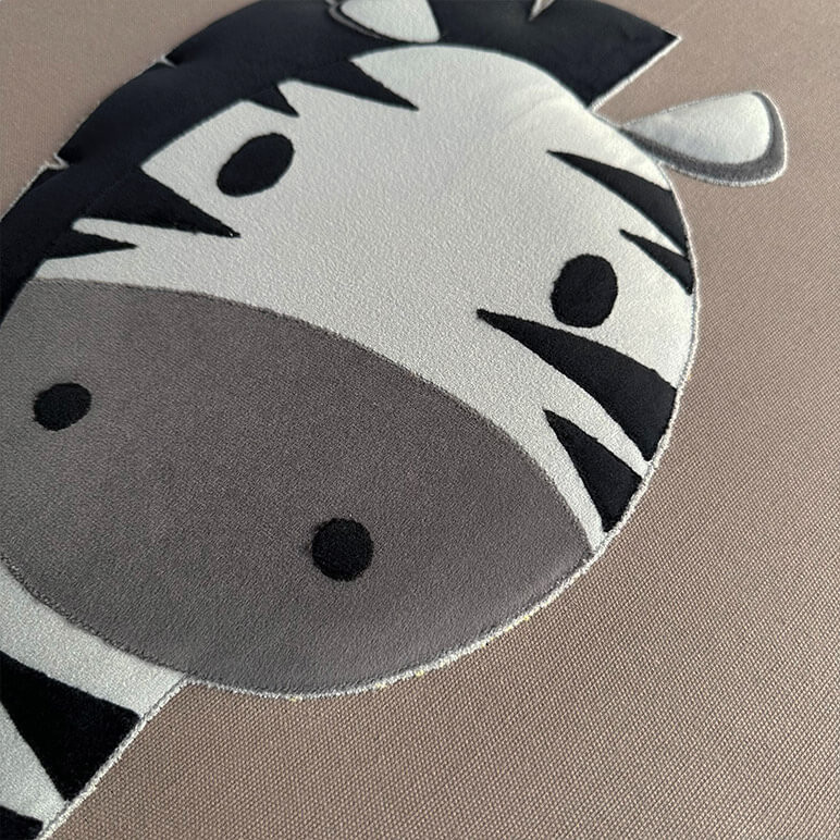 closeup view of an embroidered zebra wall art for kids rooms