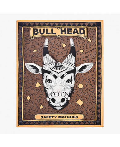 framed 3d textile wall art showcasing an enlarged vintage matchbox crafted using metallic embroidery to form a sculpted bull's head decorated with ornaments, seen over an earthy brown suede fabric. Has the titles 