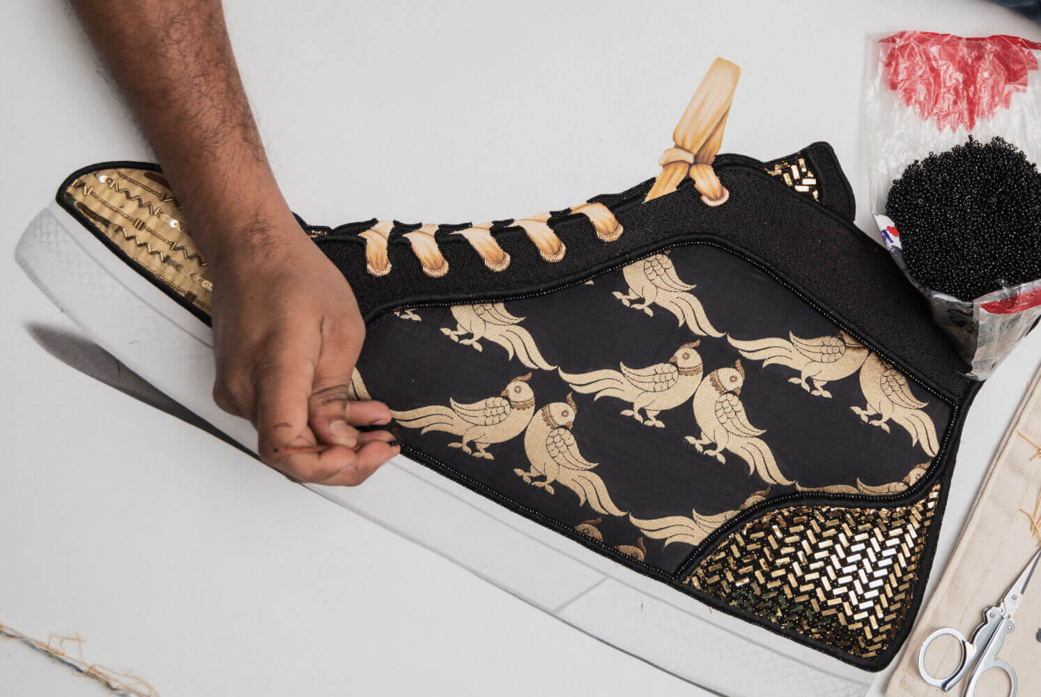 making of a limited edition sneaker textile artwork in black and gold